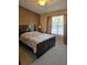 Spacious bedroom with a large bed and a window providing natural light at 30119 Wellesley Way, Wesley Chapel, FL 33543