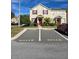 Two-story townhome with red door and landscaping at 30119 Wellesley Way, Wesley Chapel, FL 33543