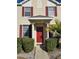 Townhome entrance with red door and red shutters at 30119 Wellesley Way, Wesley Chapel, FL 33543