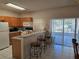Galley kitchen with breakfast bar and patio access at 30119 Wellesley Way, Wesley Chapel, FL 33543