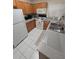 Bright and airy kitchen with white appliances and wood cabinets at 30119 Wellesley Way, Wesley Chapel, FL 33543