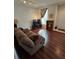Living room with brown couches and wood-look floors at 30119 Wellesley Way, Wesley Chapel, FL 33543