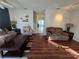 Living room with brown couches and wood-look floors at 30119 Wellesley Way, Wesley Chapel, FL 33543