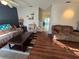 Living room with brown couches and wood-look floors at 30119 Wellesley Way, Wesley Chapel, FL 33543