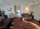 Living room with brown couches and wood-look floors at 30119 Wellesley Way, Wesley Chapel, FL 33543