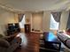 Living room with brown couches and wood-look floors at 30119 Wellesley Way, Wesley Chapel, FL 33543
