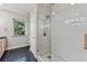 Modern bathroom with frameless shower and granite countertop at 3045 Dominion Ct, Safety Harbor, FL 34695