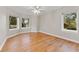 Bright bedroom with hardwood floors and multiple windows at 3045 Dominion Ct, Safety Harbor, FL 34695