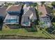 Aerial view of three homes with private pools in a community setting at 3320 Stonebridge Trl, Valrico, FL 33596