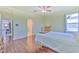 Bedroom with wood floors, queen bed, and access to bathroom at 3320 Stonebridge Trl, Valrico, FL 33596