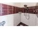 Clean bathroom with shower and maroon and white tiled walls at 3391 Knox Ter, Port Charlotte, FL 33948