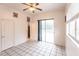 Bedroom with tiled floors and access to bathroom and patio at 3391 Knox Ter, Port Charlotte, FL 33948