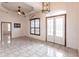 Bright and airy living room with tiled floors, a ceiling fan, and large windows at 3391 Knox Ter, Port Charlotte, FL 33948