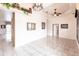 Spacious living area with tile flooring, neutral walls, and a view of a hallway at 3391 Knox Ter, Port Charlotte, FL 33948