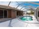 Enclosed kidney-shaped pool with patio access at 3391 Knox Ter, Port Charlotte, FL 33948