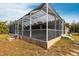 Screened pool enclosure, side yard view at 3391 Knox Ter, Port Charlotte, FL 33948