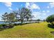 Landscaped backyard with lake view at 3404 Forsythia Dr, Odessa, FL 33556