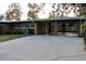 Brick carport with a concrete driveway and AC unit at 36847 Jefferson Ave, Dade City, FL 33523
