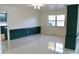 Bright dining room features a green accent wall, built in shelving, and shiny terrazzo flooring at 36847 Jefferson Ave, Dade City, FL 33523