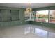 Sunlit dining room boasts a built-in shelving unit and large windows overlooking the backyard at 36847 Jefferson Ave, Dade City, FL 33523