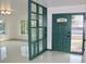 Bright entryway with green room divider and terrazzo floor at 36847 Jefferson Ave, Dade City, FL 33523