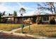 Brick ranch house with a green door, landscaped lawn, and a brick walkway at 36847 Jefferson Ave, Dade City, FL 33523