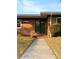 Green front door with glass panel and brick steps at 36847 Jefferson Ave, Dade City, FL 33523