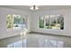 Living room with large windows and terrazzo floor at 36847 Jefferson Ave, Dade City, FL 33523