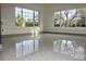 Living room with shiny terrazzo floor and large windows at 36847 Jefferson Ave, Dade City, FL 33523