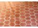 Close-up view of the reddish-brown hexagonal tile floor at 36847 Jefferson Ave, Dade City, FL 33523