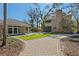 Expansive backyard featuring manicured lawn, brick walkway, and main house with additional pool house at 4407 W Dale Ave, Tampa, FL 33609