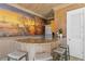 Charming bar area featuring a granite countertop, seating, stainless appliances, and a decorative hand-painted mural at 4407 W Dale Ave, Tampa, FL 33609