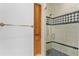 Elegant bathroom featuring a tiled walk-in shower and built-in wooden shelving at 4407 W Dale Ave, Tampa, FL 33609