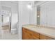 Bright bathroom featuring a wooden vanity with a stone countertop and a framed mirror at 4407 W Dale Ave, Tampa, FL 33609