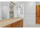 Elegant bathroom featuring a wooden vanity, stone countertop and tiled walk-in shower at 4407 W Dale Ave, Tampa, FL 33609