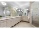 Bathroom with double vanities, large mirrors, and a glass-enclosed shower at 4407 W Dale Ave, Tampa, FL 33609