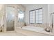 Luxurious bathroom featuring a soaking tub and separate glass shower at 4407 W Dale Ave, Tampa, FL 33609