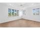 Bright, empty bedroom showcasing large windows, a ceiling fan, and hardwood floors at 4407 W Dale Ave, Tampa, FL 33609