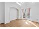 Bright bedroom with hardwood floors, an archway, and french doors leading to a balcony at 4407 W Dale Ave, Tampa, FL 33609