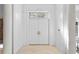 Elegant foyer featuring double doors with stained glass transom and neutral tiled floors at 4407 W Dale Ave, Tampa, FL 33609