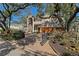 Charming brick home with wrought iron gate, mature trees, and meticulously maintained landscaping at 4407 W Dale Ave, Tampa, FL 33609