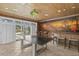 Bright game room boasts a ping pong table, bar stools, and seamless indoor-outdoor flow through shuttered glass doors at 4407 W Dale Ave, Tampa, FL 33609