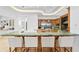Spacious kitchen with custom wood cabinets, bar seating, and a unique natural stone countertop at 4407 W Dale Ave, Tampa, FL 33609