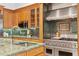 The gourmet kitchen features custom cabinetry, mosaic backsplash, stainless steel appliances, and a Wolf range at 4407 W Dale Ave, Tampa, FL 33609