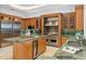 Gourmet kitchen featuring custom cabinetry, stainless steel appliances, and a kitchen island at 4407 W Dale Ave, Tampa, FL 33609