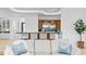 Living room view into kitchen, featuring a large center island with seating and modern appliances at 4407 W Dale Ave, Tampa, FL 33609