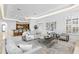 Open-concept living space with a large area rug, neutral-toned furniture, and recessed lighting at 4407 W Dale Ave, Tampa, FL 33609
