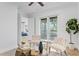 Bright seating area featuring two chairs, modern decor, and french doors to a balcony with views at 4407 W Dale Ave, Tampa, FL 33609
