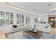Bright living room featuring neutral furnishings, decorative rug, and large windows with shutters at 4407 W Dale Ave, Tampa, FL 33609