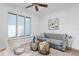 Cozy living room with large window, gray sofa, and unique side tables at 4407 W Dale Ave, Tampa, FL 33609